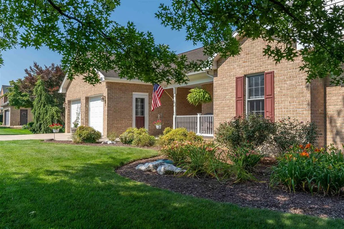 Brick home with American flag and landscaped yard in Belmont Estates, Harrisonburg VA